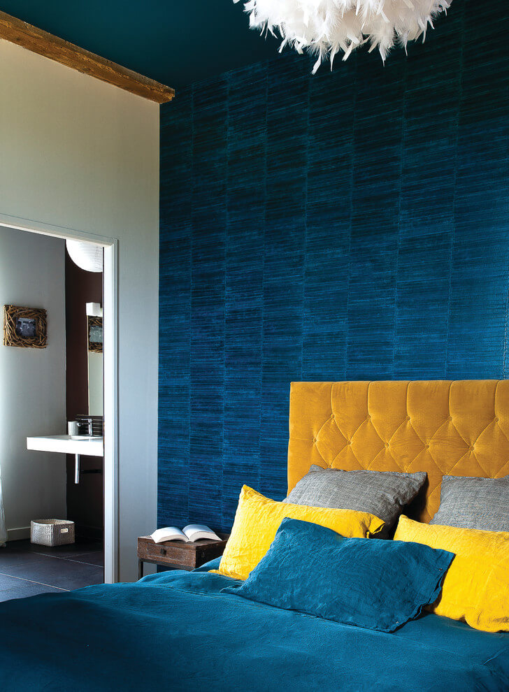 Yellow accents in blue bedroom