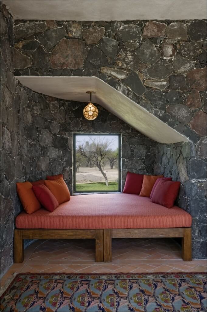 alcove bed with stone walls and pendant lights