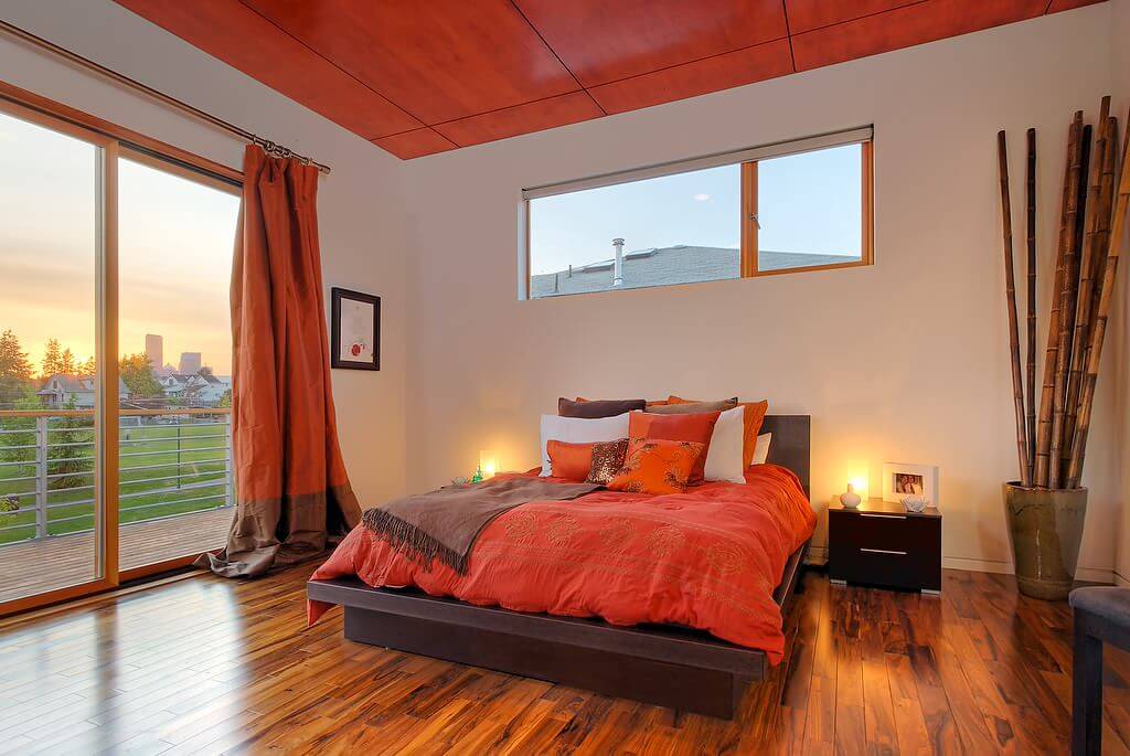 Solid orange curtains Minimalist Medium Tone wood flooring modern bedroom