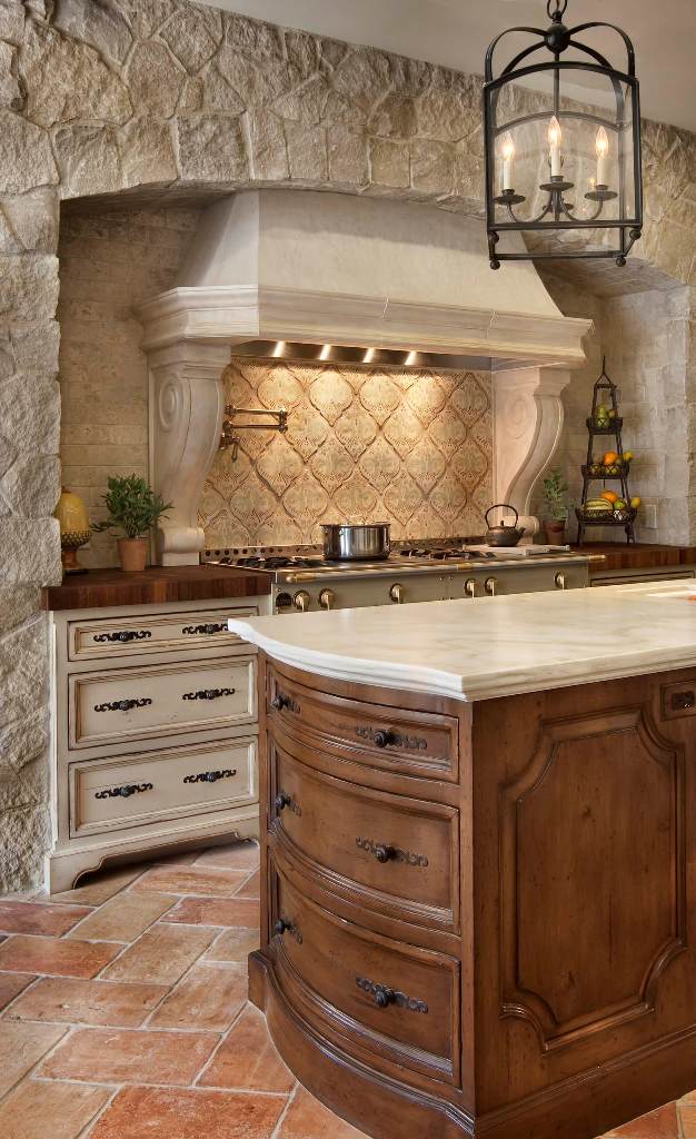 Rustic stone-sided modern fireplace and countertops in Tuscan kitchen