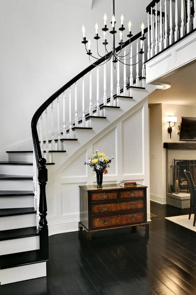 Traditional staircase with black wooden floors