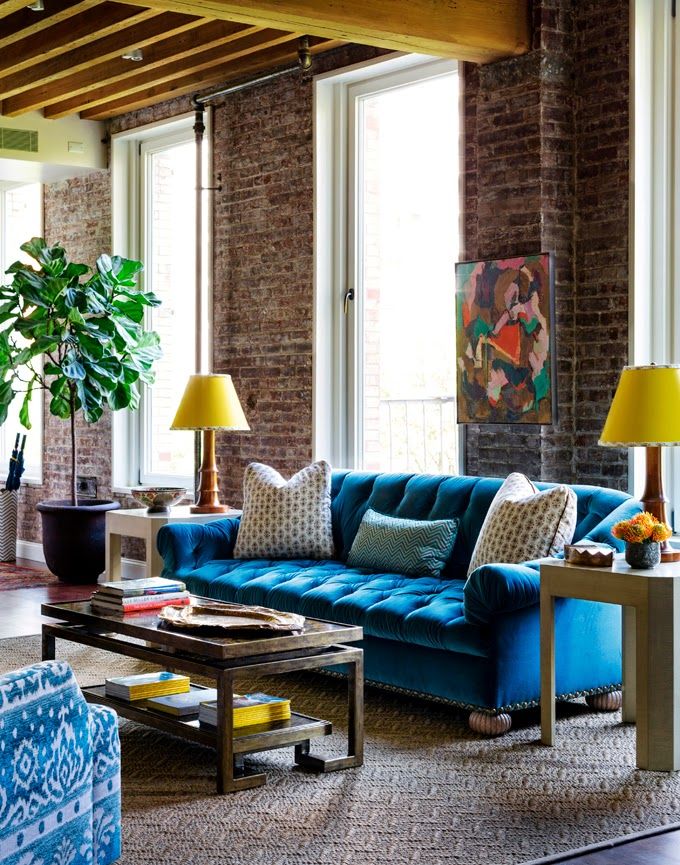 Living room with high ceiling brick wall