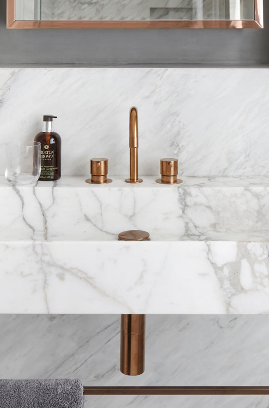 Bathroom in marble sink Copper fixtures
