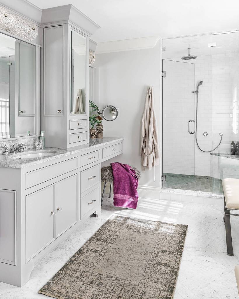 White bathroom design with traditional rug