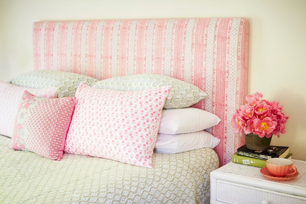 Arrange the pillow on a bed