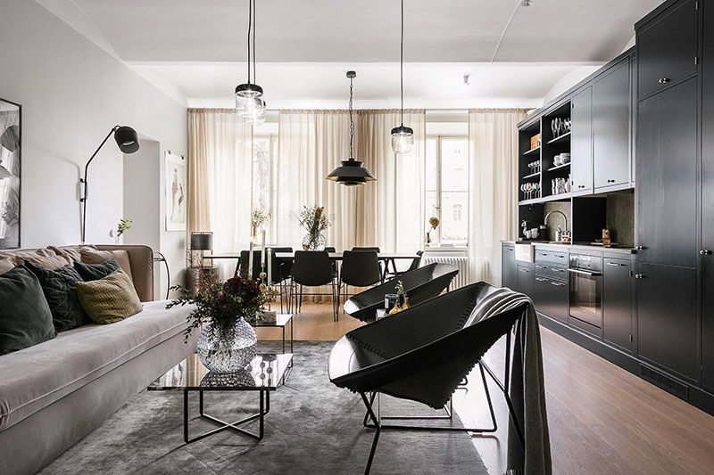 Swedish apartment with black kitchen and large windows (91 sqm .