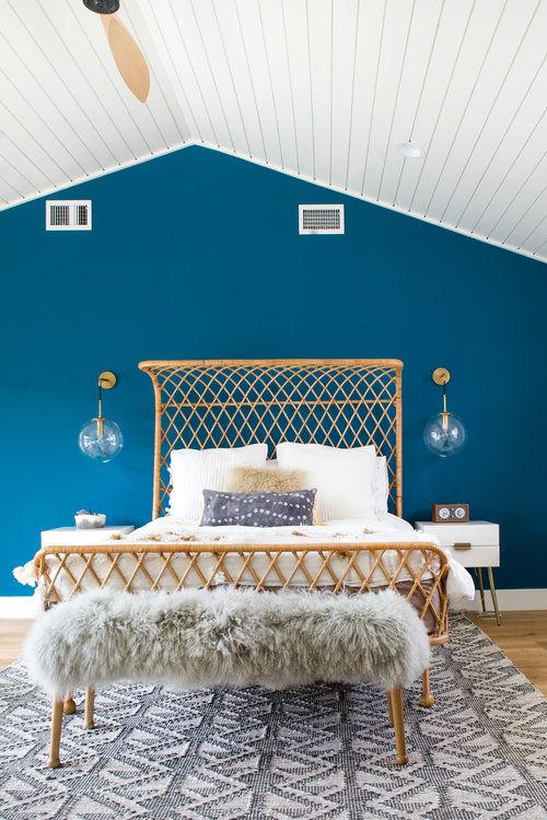 Modern Bohemian Bedroom with Rattan Bed Frame and Bright Blue .