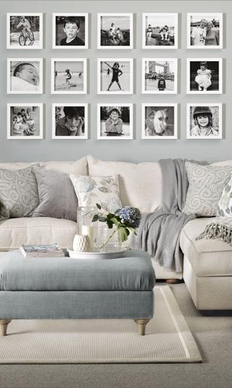 A black and white photo wall looks perfect in this white and grey .