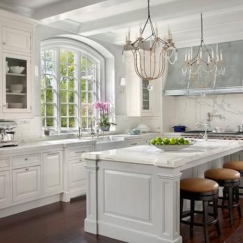 Modern French kitchen with white kitchen cabinets paired with .