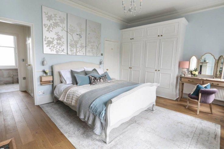 Soft hues of pale blue, grey and white give the bedroom a serene .