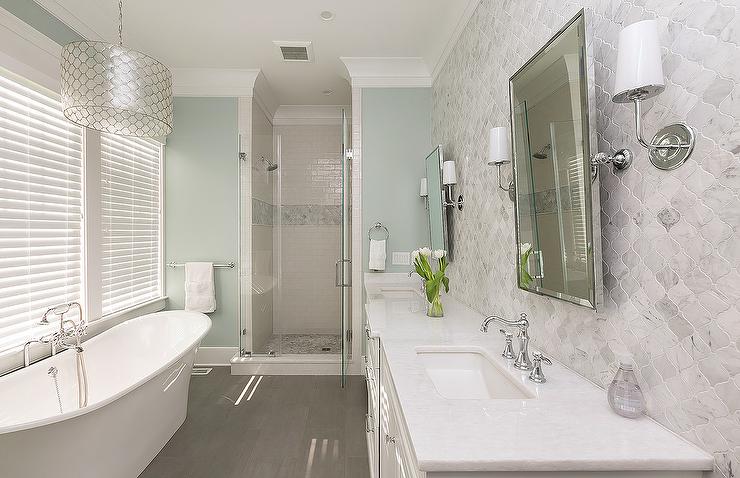 White and Blue Spa Like Bathroom with Gray Wood lIke Floor Tiles .