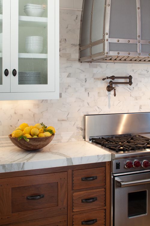 wood tone kitchen cabinets with marble or quartzite counter and .