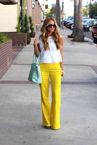 yellow flared sailor trousers with white sleeveless lace top