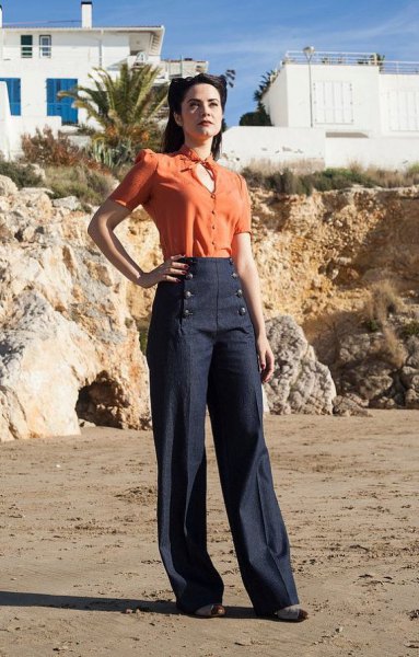 orange key hold blouse with dark blue sailor trousers with wide legs