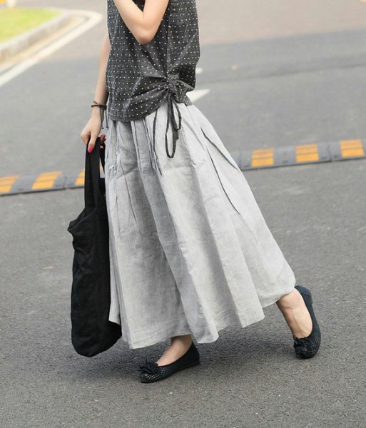 sleeveless blouse with black and white polka dots and a light gray maxi linen skirt