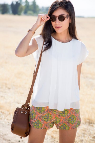 white chiffon top with cap sleeves and orange, flowing shorts