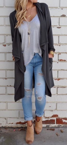 Low-cut t-shirt with a dark gray sweater and ripped jeans
