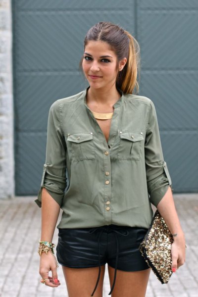 Army green shirt with buttons and black mini leather shorts