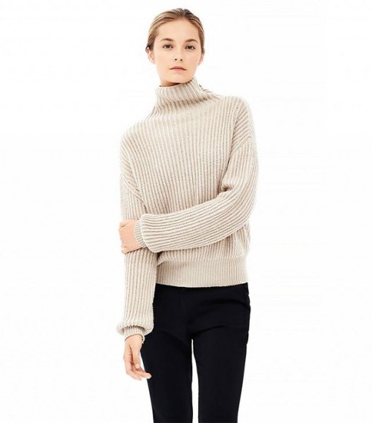 beige tube sweater with mock neck, black tube jeans