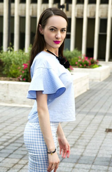 light blue blouse with bell sleeves and checked trousers