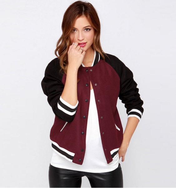 casual baseball jacket in black and burgundy with white t-shirt and leather gaiters