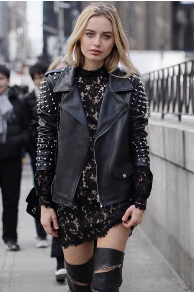 Leather jacket with black and silver spikes and a lace mini dress