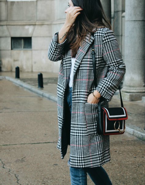 Black and white checked coat with a white top and blue jeans