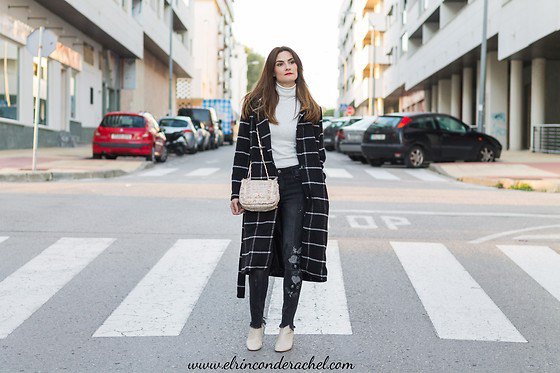 black and white checked long wool coat with white sweater with a mock neck