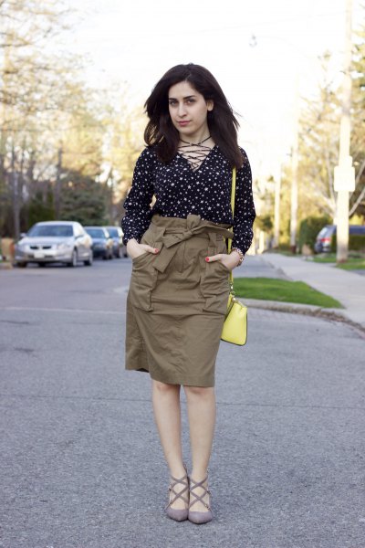 Black and white polka dot blouse with a green cargo high skirt