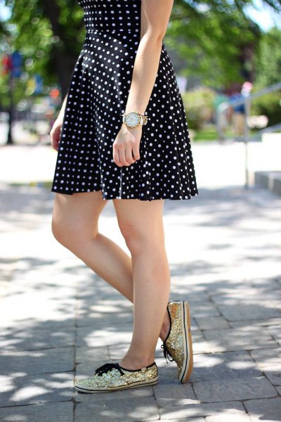 black and white polka dot and flared mini dress with gold sequin sneakers