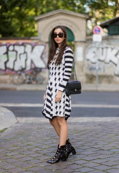 black and white striped mini dress with pointed toe boots made of leather