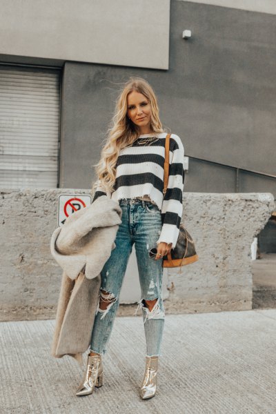 black and white striped sweater with ripped jeans and gold boots