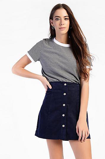 black and white striped t-shirt with a high-waisted corduroy skirt