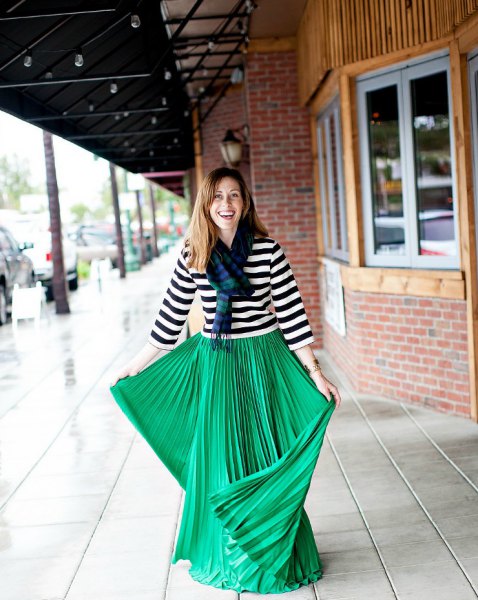black and white striped three-quarter T-shirt with a green pleated maxi skirt