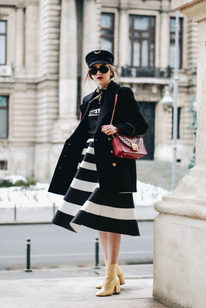 black and white wide striped midi dress with brown leather shoulder bag