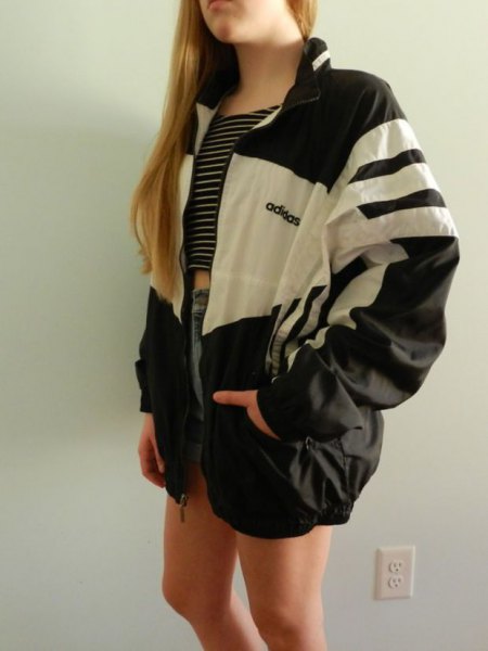 Black and white windbreaker with a striped crop top and denim shorts