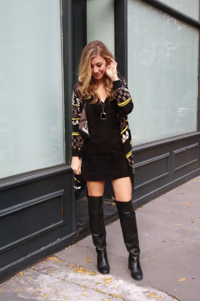 black and yellow printed cardigan with mini shift dress and long leather boots