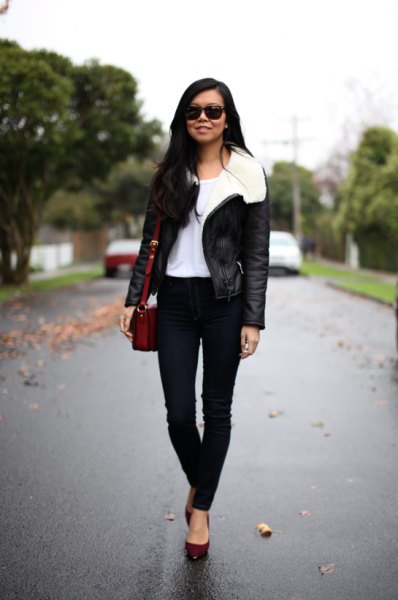 black aviator jacket with white fur collar and skinny jeans