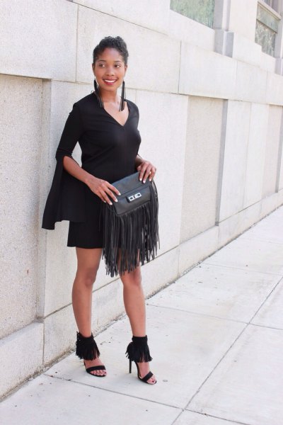 black shift dress with bell sleeves and wallet with leather fringes
