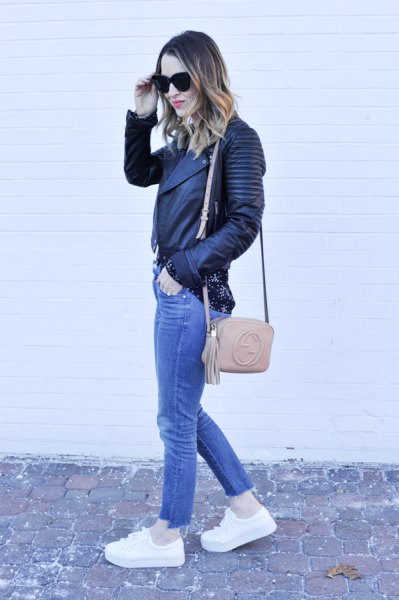 black biker leather jacket with blue jeans and white platform sneakers