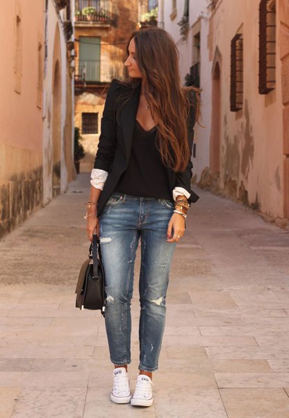 black blazer with a deep V-neck tank top and short jeans