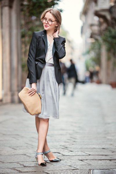 black blazer with gray pleated dress and black kitten heel shoes with ankle straps