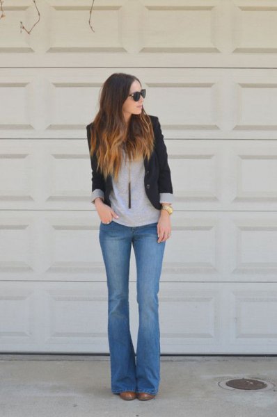 black blazer with gray t-shirt and blue flare jeans