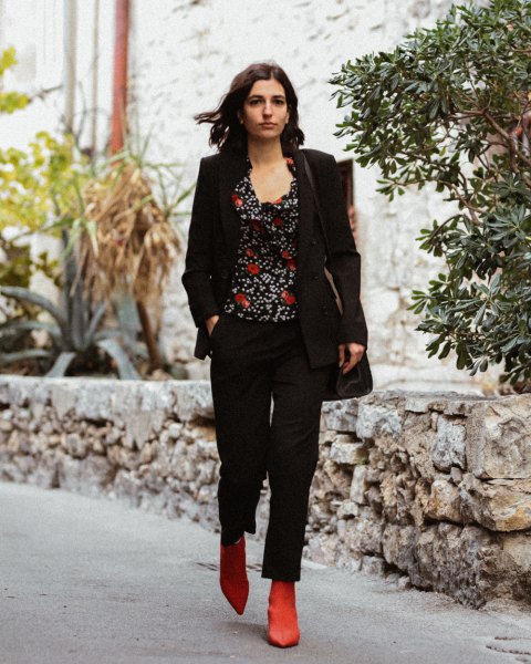 black blazer with printed top with scoop neckline and brown ankle on the boot