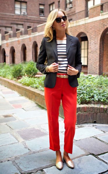 black blazer with red, cropped trousers and gold slippers