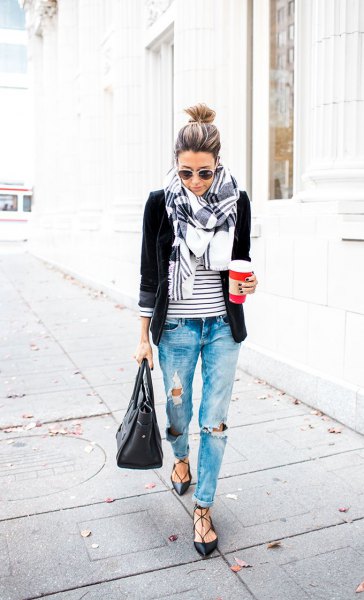 black blazer with a striped T-shirt and badly torn boyfriend jeans