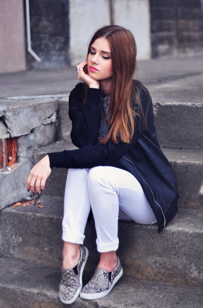 black bomber jacket with white jeans with cuffs and gray printed hiking boots
