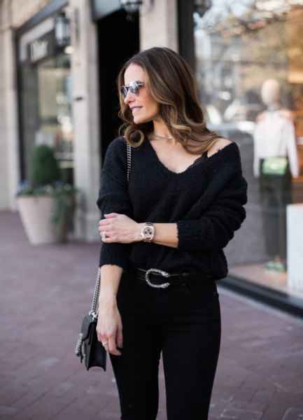 black bralette with a V-neck sweater and skinny jeans