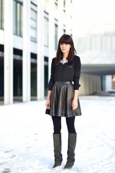 black shirt with buttons and flared leather high skirt