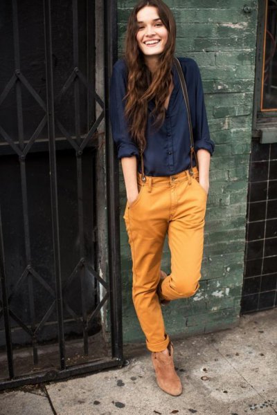black shirt with buttons and mustard yellow jeans